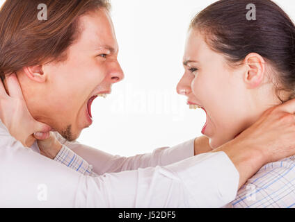 Close-up portrait of a pair of angry shouting against each other on a white background Stock Photo