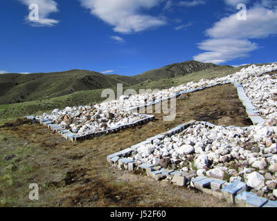 Arrow on a hill pointing upwards to the sky. Stock Photo