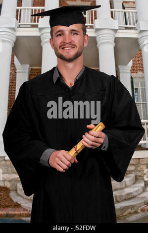 Young man in his graduation robes Stock Photo