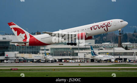 Air Canada Rouge plane airplane aeroplane Boeing 767 (767-300ER) wide-body jetliner take taking off Vancouver International Airport Westjet planes at  Stock Photo