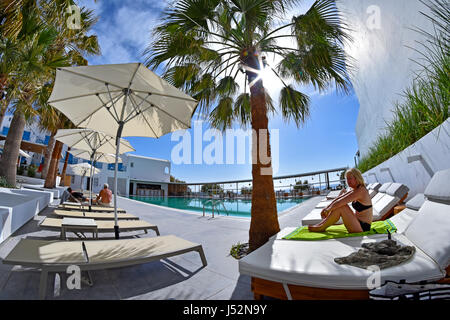Tourist relaxing in the Kamari Beach Hotel, Santorini Cyclades Greek Islands Greece Stock Photo