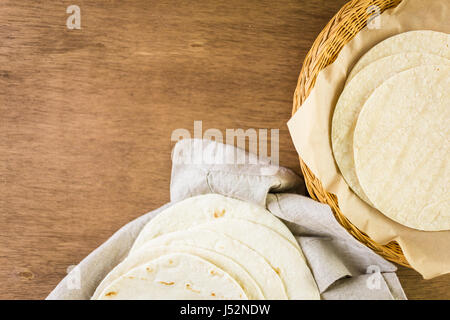 Variety of fresh tortillas on a wood background. Stock Photo