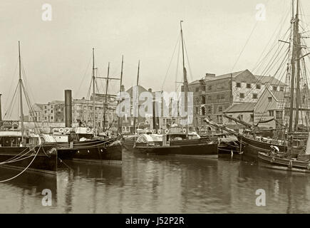 Paddle steamers and sailing ships in the harbour at Weymouth, Dorset, c. 1900. On the quay are warehouses and other industrial buildings and two pubs, The Ship Inn and the Royal OakRoyal Stock Photo