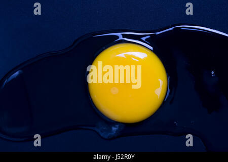 The broken egg on black background. Stock Photo