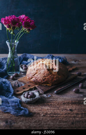 Freshly baked sweet Easter bread on a wooden board Stock Photo