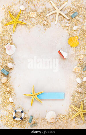 Shells and starfishes on sand background with place for text. Top view, vintage toned image Stock Photo