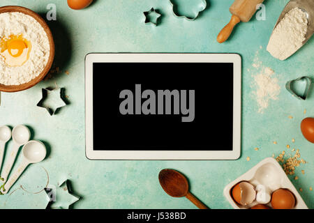 https://l450v.alamy.com/450v/j538bd/baking-background-with-flour-eggs-kitchen-tools-and-tablet-computer-j538bd.jpg