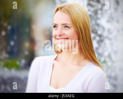 Young woman walking by the River Thames, London Stock Photo
