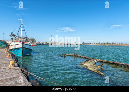 LAAIPLEK, SOUTH AFRICA - APRIL 1, 2017: Fishing ships and a sunken boat in the harbor at the mouth of the Berg River at Laaiplek on the Atlantic coast Stock Photo