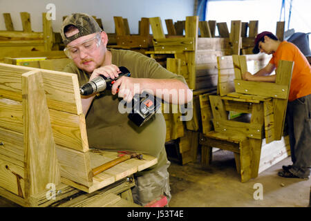 Arkansas Randolph County,Pocahontas,Sturdy Outdoor Furniture Company,wood benches,man men male,worker,workers,carpenter,battery operated electric dril Stock Photo