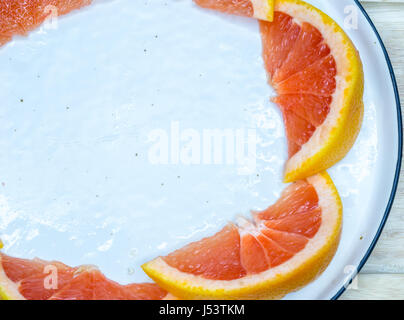Fresh Red Grapefruit Slice On Table, close up Stock Photo
