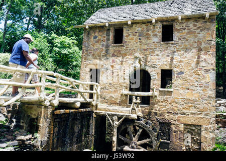 Little Rock Arkansas,T.R. Pugh Memorial Park,The Old Mill,appeared in Gone With The Wind,Black man men male,woman female women,bridge,stone building,g Stock Photo