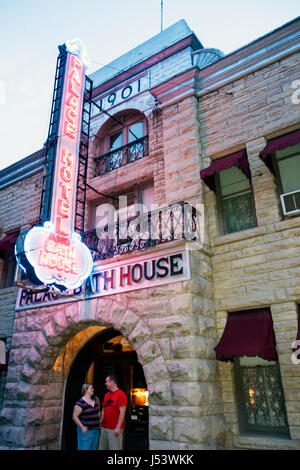 Eureka Springs Arkansas,Ozark Mountains,Palace Hotel and Bath house houses home homes residence,built 1901,neon sign,entrance,front,dusk,evening,night Stock Photo