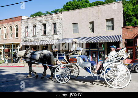 Eureka Springs Arkansas,Ozark Mountains,horse drawn carriage,driver,buildings,city skyline,renovated,preservation,facade,stone,AR080610078 Stock Photo
