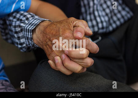 nephew holding strong grandfather's hand Stock Photo