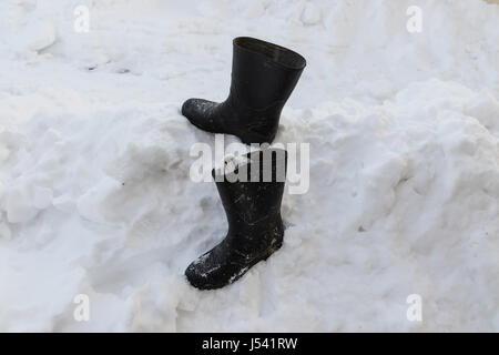 black boots on snow hill Stock Photo