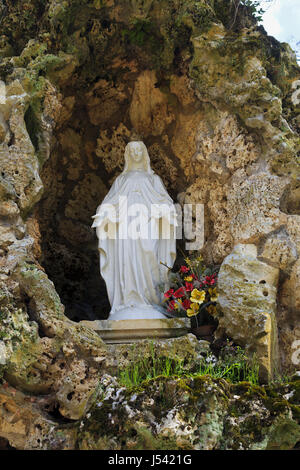 Statue of Our Lady of Lourdes in the Grotto in the grounds of Château de Sully in the Loire Valley, France Stock Photo