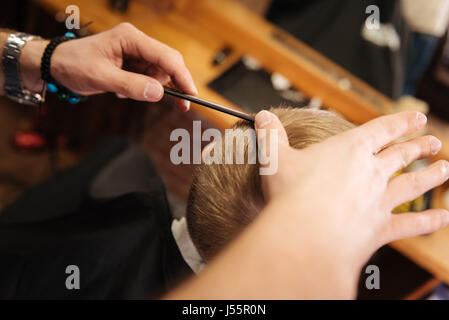 Comb being used by a professional barber Stock Photo