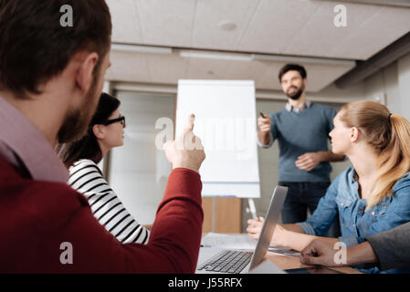 Back view of bearded man pointing on speaker Stock Photo