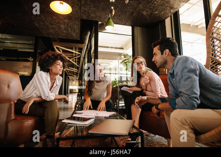Group of creative people having a meeting in a modern office. Business people having conversation over new project. Stock Photo