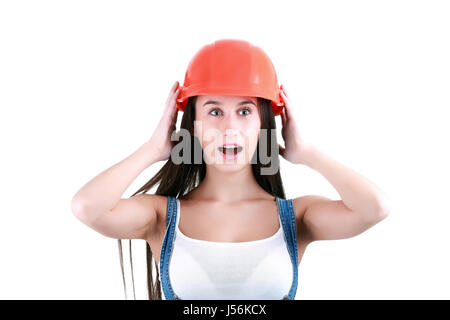 Portrait of young female builder in helmet painting on white Stock Photo