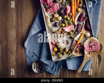 Brussel sprouts and root vegetables with capers from the oven Stock Photo