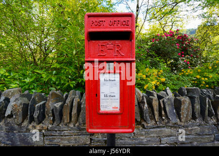 Traditional Red British Post Office Box for collecting letters for delivering. Stock Photo