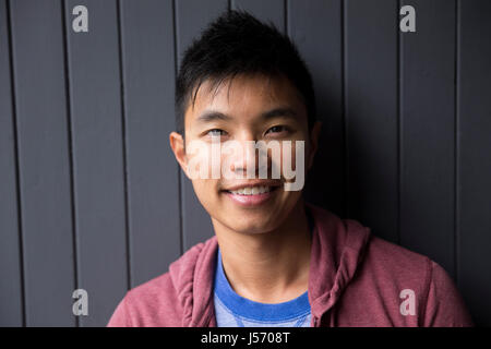 Portrait of a trendy urban Chinese man. Urban man in street. Stock Photo