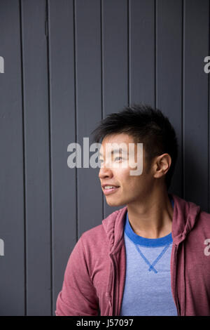 Portrait of a trendy urban Chinese man. Urban man in street. Stock Photo