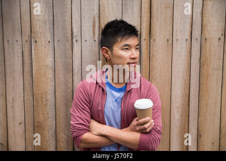 Portrait of a trendy urban Chinese man. Urban man in street. Stock Photo