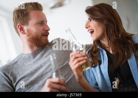 Young beautiful couple flirting and smiling at home Stock Photo