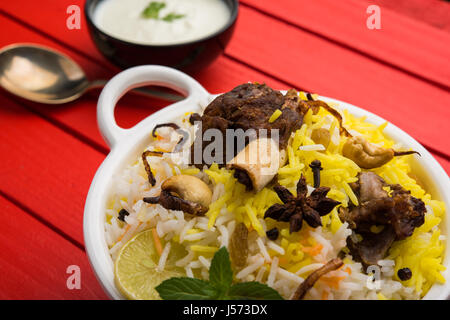 kashmiri Mutton Gosht Biryani / Lamb Biryani / Mutton Biryani served with Yogurt dip, selective focus Stock Photo