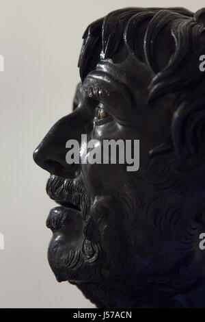 Bronze bust of the so-called Pseudo-Seneca. Roman copy from the 1st century AD after a Greek original from the end of the 2nd century BC found in the rectangular peristyle in the Villa dei Papiri (Villa of the Papyri) in Herculaneum on display in the National Archaeological Museum in Naples, Campania, Italy. The bust was hoped to be a portrait of Roman Stoic philosopher Seneca the Younger, until the inscribed Roman portrait was identified, now generally identified as an imaginative portrait of either Hesiod or Aristophanes. Stock Photo