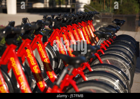 A row of Capital Bike Share bicycles in a rack on a sidewalk in Washington DC Stock Photo