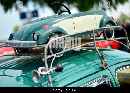 A VW Beetle with a historical pedal car on it parks at the Maikaefertreffen (May Beetle Meeting) in Hanover (Germany), 01 May 2017. Fans and owners of Beetles and VW Transporters got together to show their classic cars. | usage worldwide Stock Photo