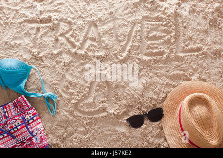 Travel written in a sandy tropical beach Stock Photo