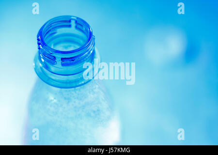 Open mineral water bottle in blue with shallow depth of field. Copy space on right. Stock Photo