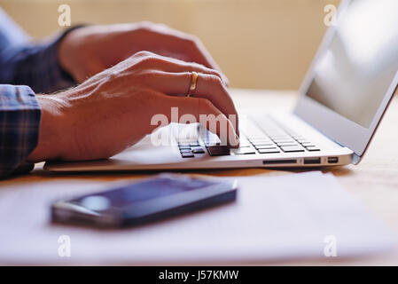 Close-up of a worker using a laptop computer. Stock Photo