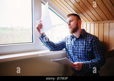 Businessman at home, he is working with of paper. Stock Photo