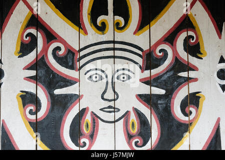 Indonesia, Traditional Dayak tribal culture. Traditional picture on Dayak house - longhouse in Mahak village. East Kalimantan, Indonesia, Borneo. Stock Photo