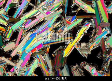 Microscopic view of colorful potassium nitrate crystals. Polarized light, crossed polarizers. Stock Photo