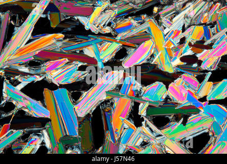 Microscopic view of colorful potassium nitrate crystals. Polarized light, crossed polarizers. Stock Photo