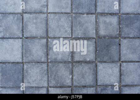 Concrete paving texture, top view of tiled gray square shaped slabs Stock Photo
