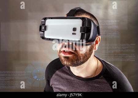 Young man experiencing virtual reality through a VR headset Stock Photo