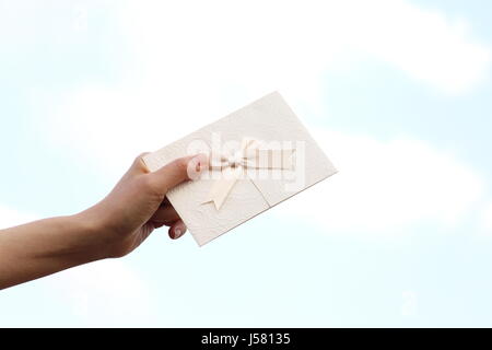 Woman Hand Holding Invitation Card Stock Photo