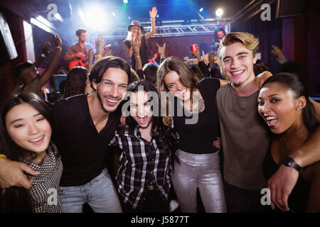 Portrait of cheerful friends enjoying at nightclub during music festival Stock Photo