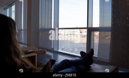 FRANKFURT - SEPTEMBER 2014: female Passenger sitting in a comfy chair at the Lufthansa First Class Lounge in Frankfurt Stock Photo