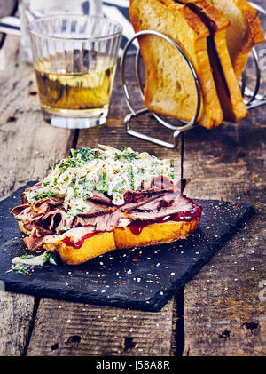 Beef brisket sandwich with kale coleslaw and barbecue sauce Stock Photo