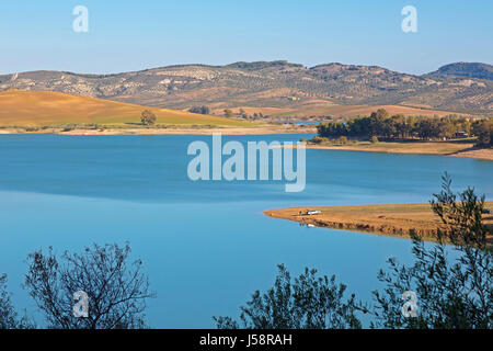 View across Guadalhorce dam, Malaga Province, Andalusia, Spain, to farmland beyond. Embalse de Conde de Guadalorce. Stock Photo