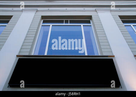Mock up. Blank billboard outdoors, outdoor advertising, public information board on the wall under window Stock Photo